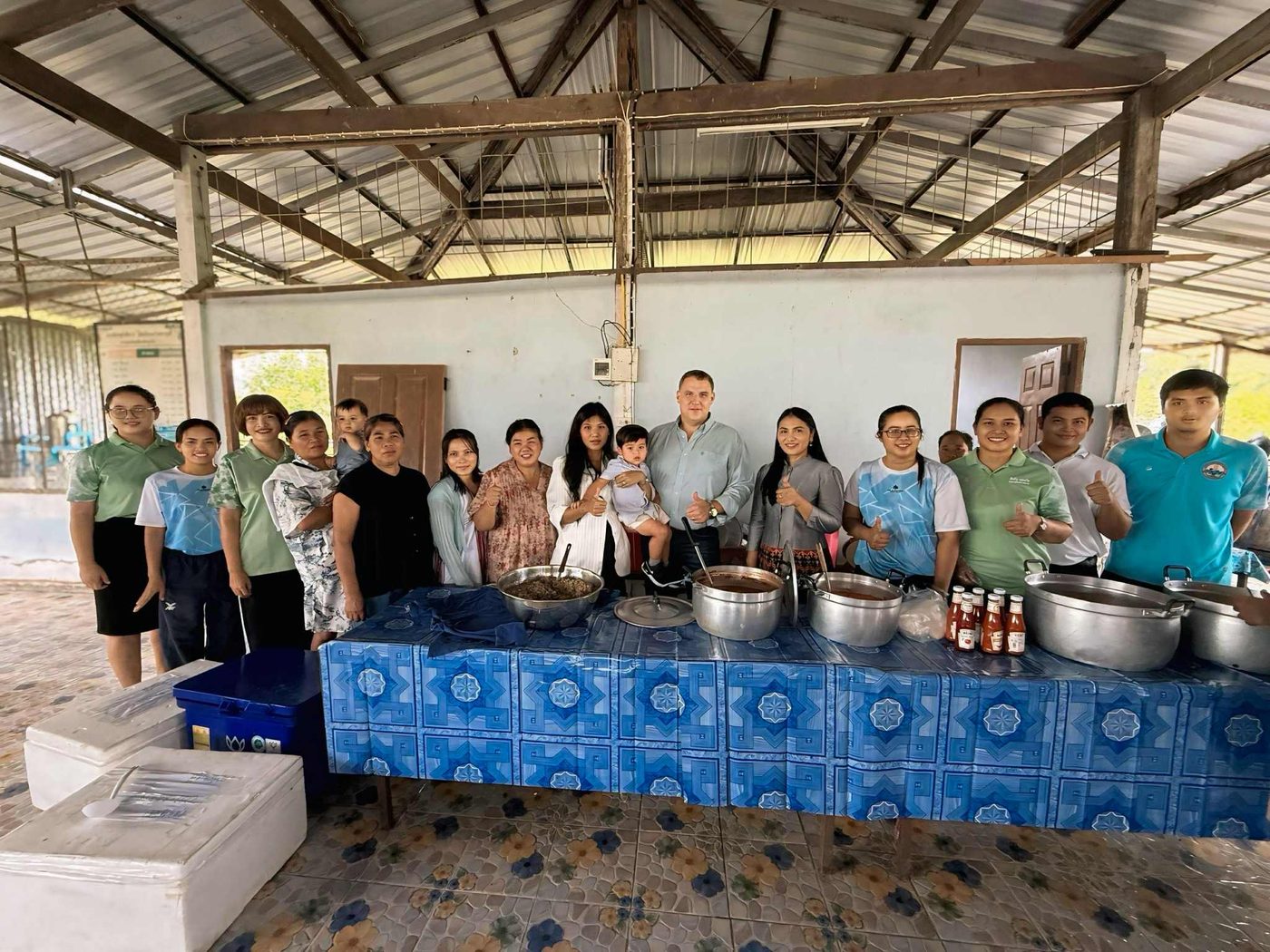 Benjamin Cunningham with community members and teachers at a village gathering in Surin Province, Thailand